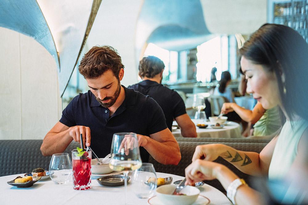 Couple enjoying a delicious meal at a restaurant in Madrid.