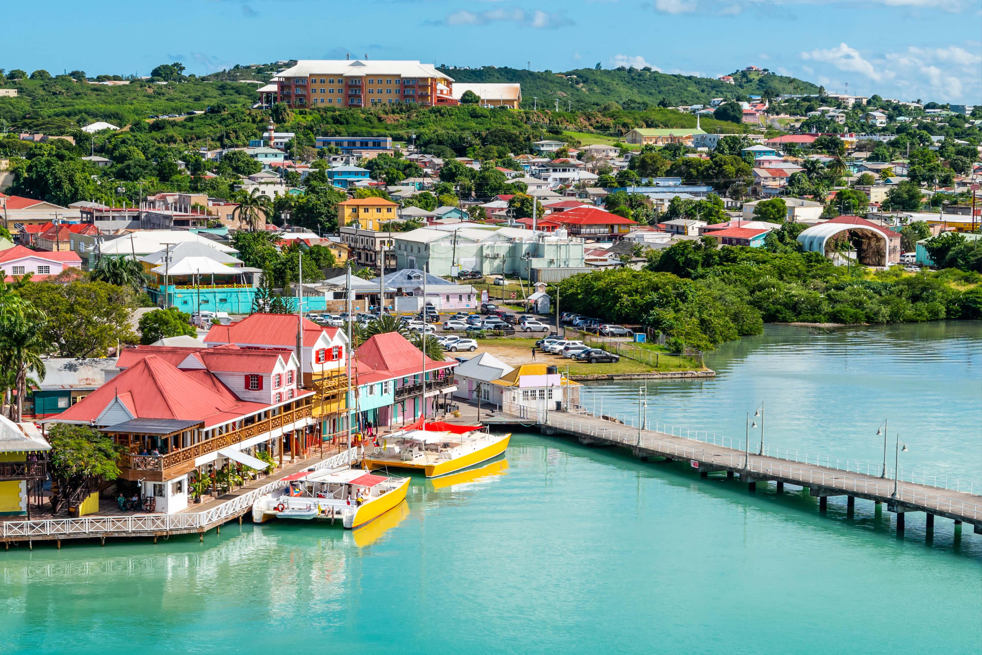 Aerial view of colorful seaside town and turquoise waters in Antigua