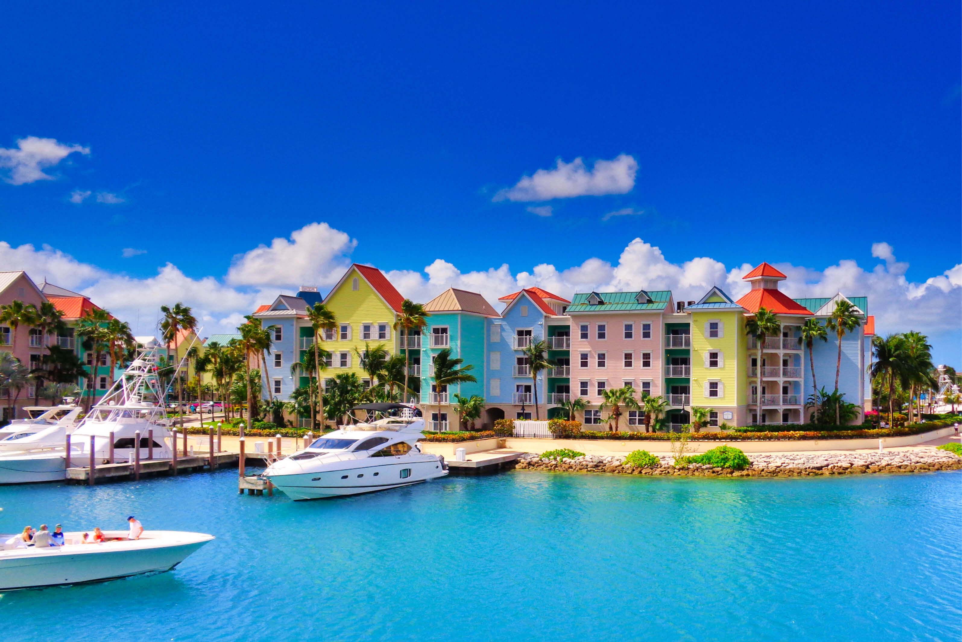 Colorful pastel buildings line boat docks in Nassau, Bahamas