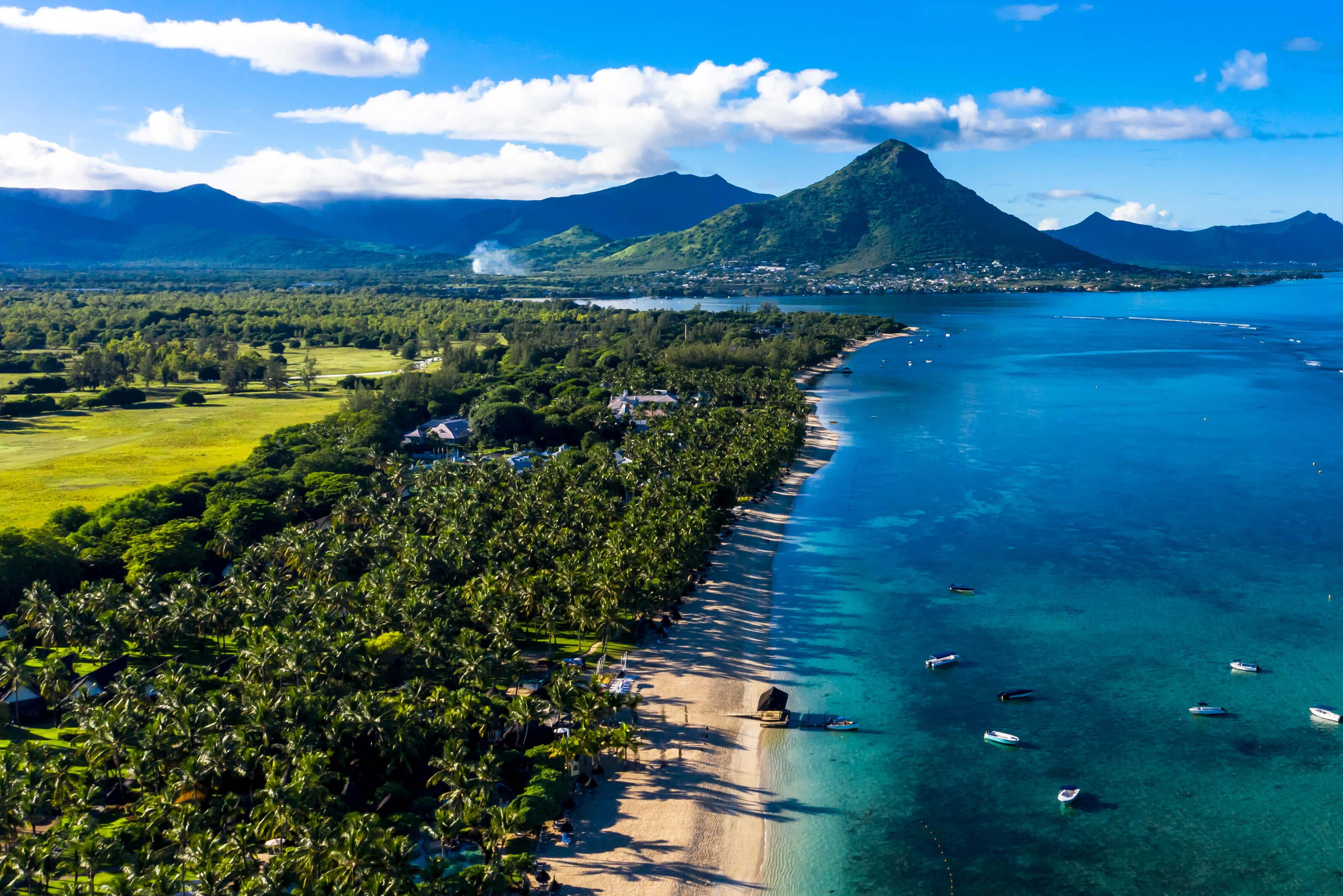 Stunning beach with turquoise waters and lush mountains in Mauritius, showcasing natural beauty and tranquility