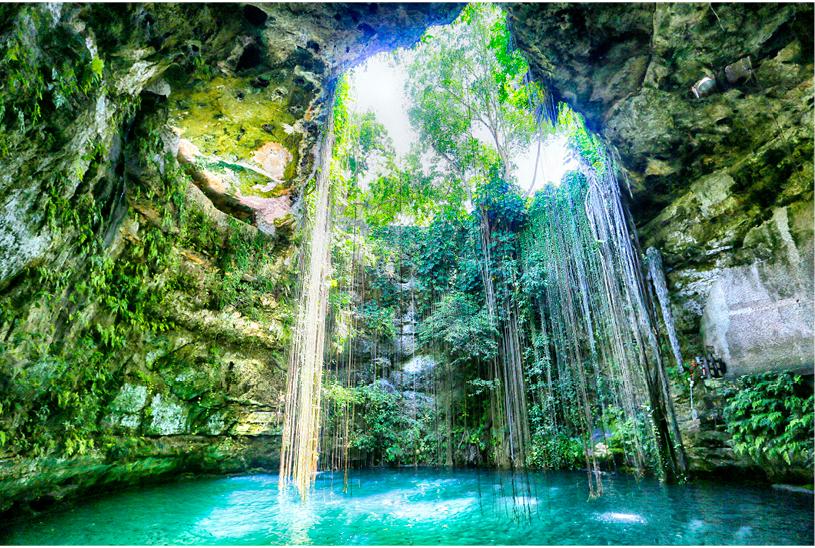 A serene cenote in Mexico, soft light slicing through an opening overhead