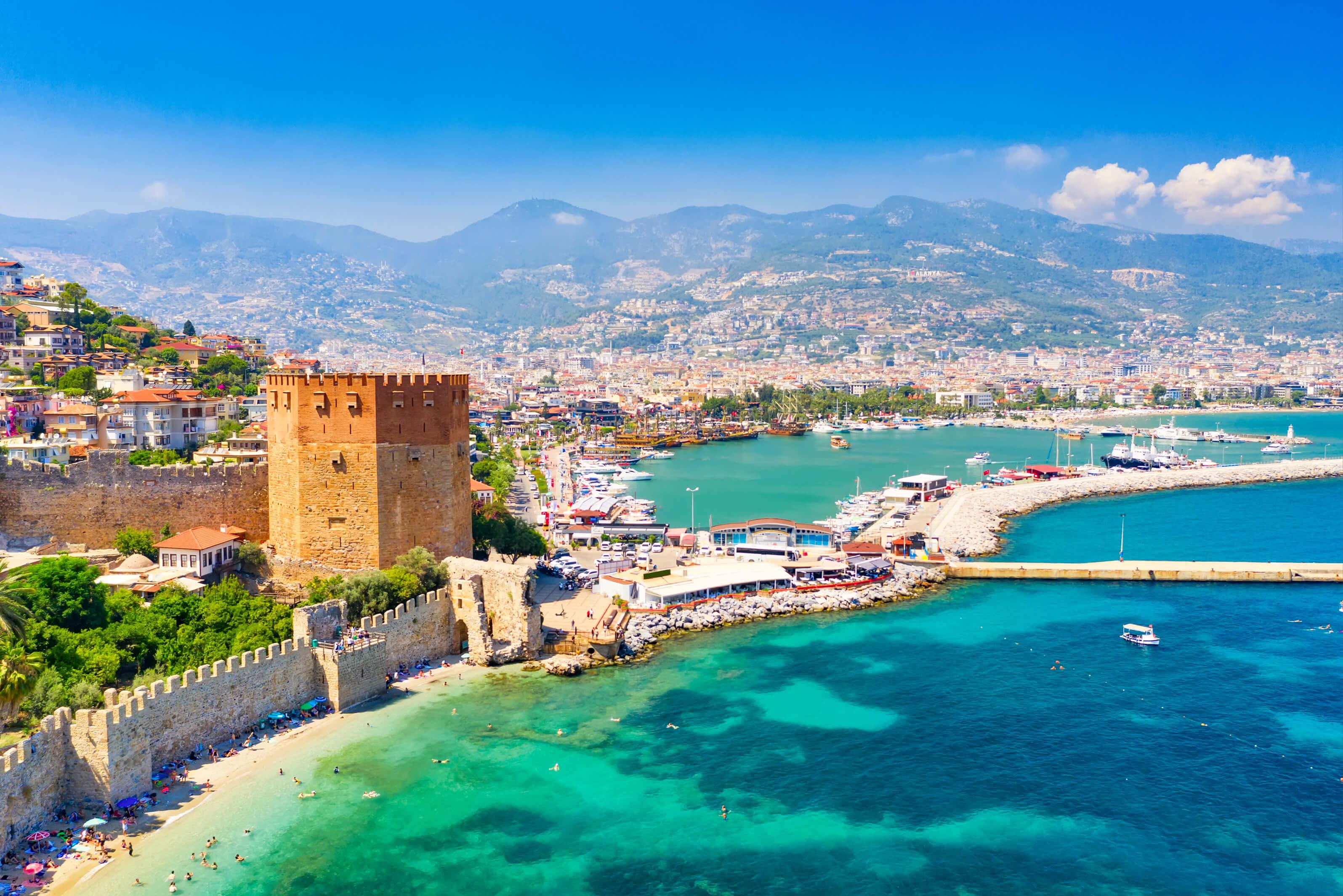Alanya, Turkey, featuring its colorful cityscape, beaches, azure waters, and the Alanya Castle on a sunny day