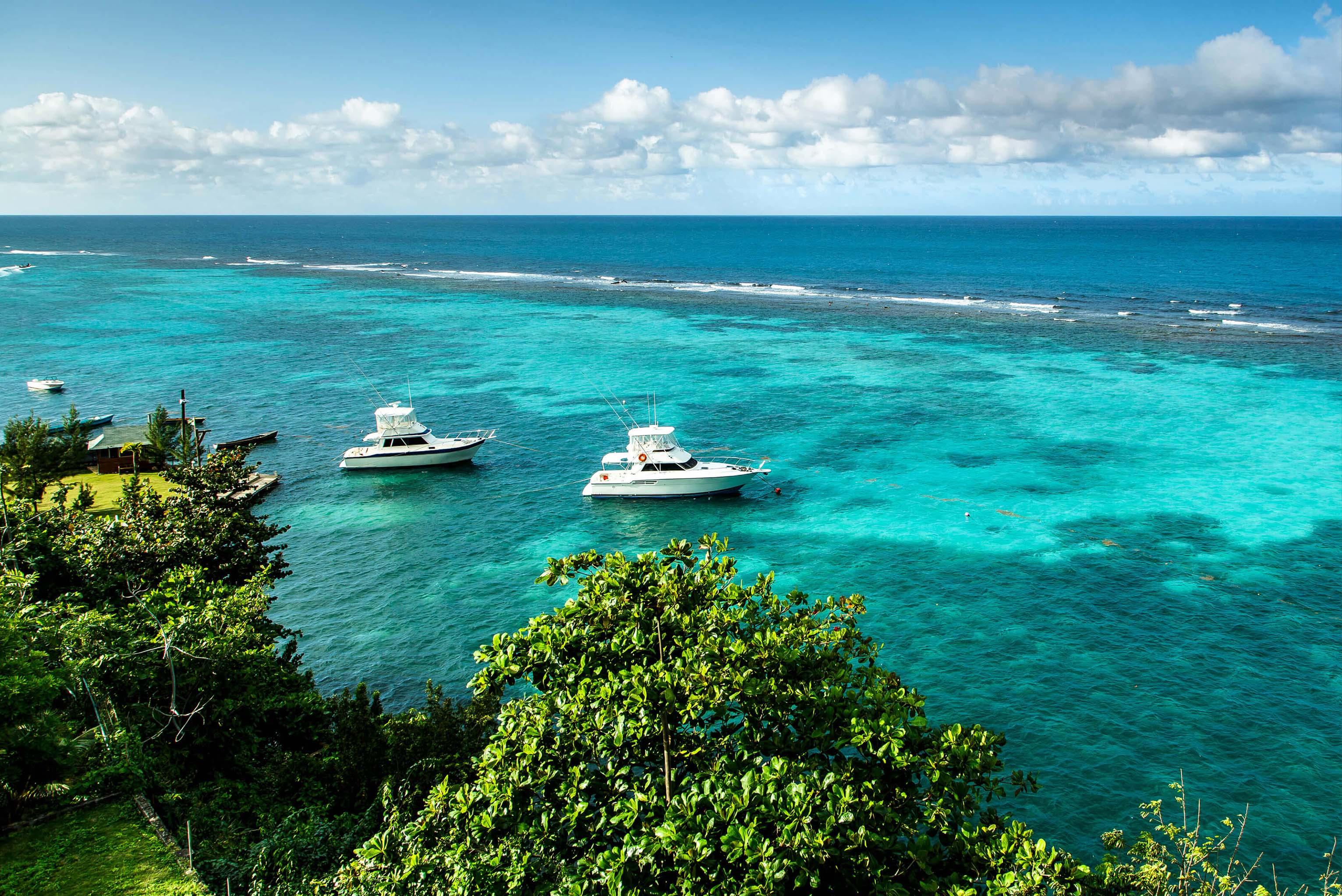 Boats floating on the turquoise ocean water of Ocho Rios, Jamaica