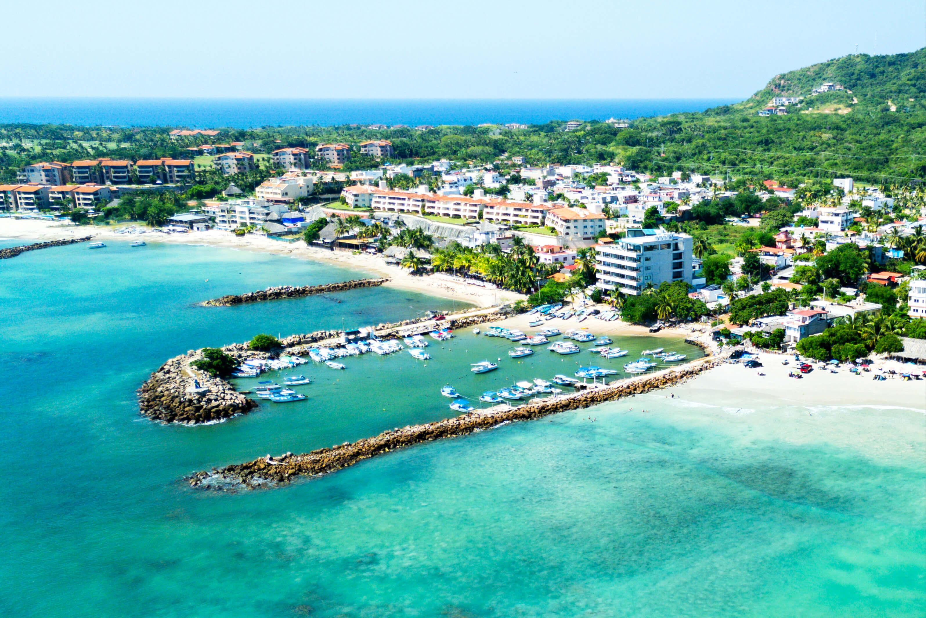 Resort area along the coast in Riviera Nayarit, Mexico featuring long docks and turquoise waters