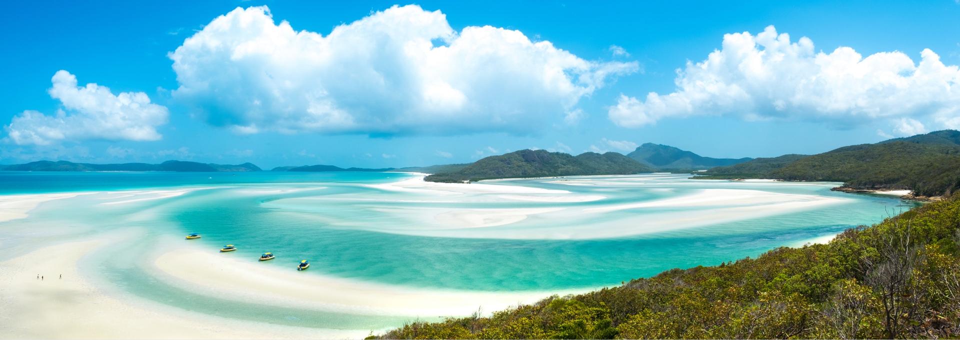 Panoramic view of turquoise water and white sand swirls at a tropical beach